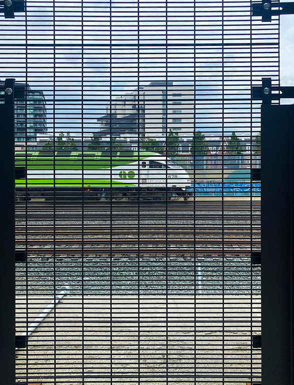 Omega MAX security fence panel in front of a GO Train at the King High Line in Toronto.