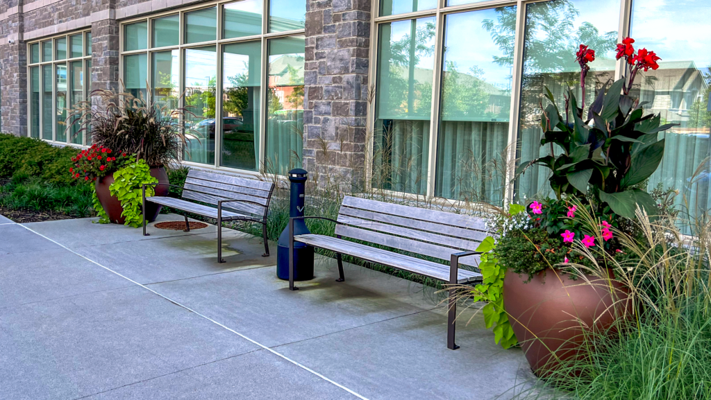 Victor Stanley benches and Old Town Fiberglass planters on an outdoor patio at Lakeridge Heights Retirement Residence in Whitby, Ontario.