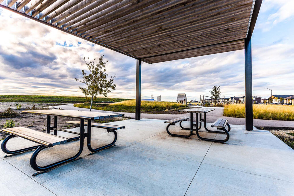 F-565 picnic tables from Victor Stanely's site furniture line located under a pergola at Shaheed Bhagat Singh Park.