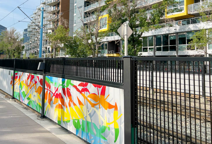 Omega 20 Grating fence system integrated with painted art panels at Bow to Bluff in Calgary.