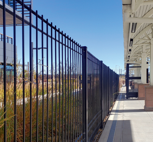 Omega Classic solid steel rod ornamental fence system at a transit station.