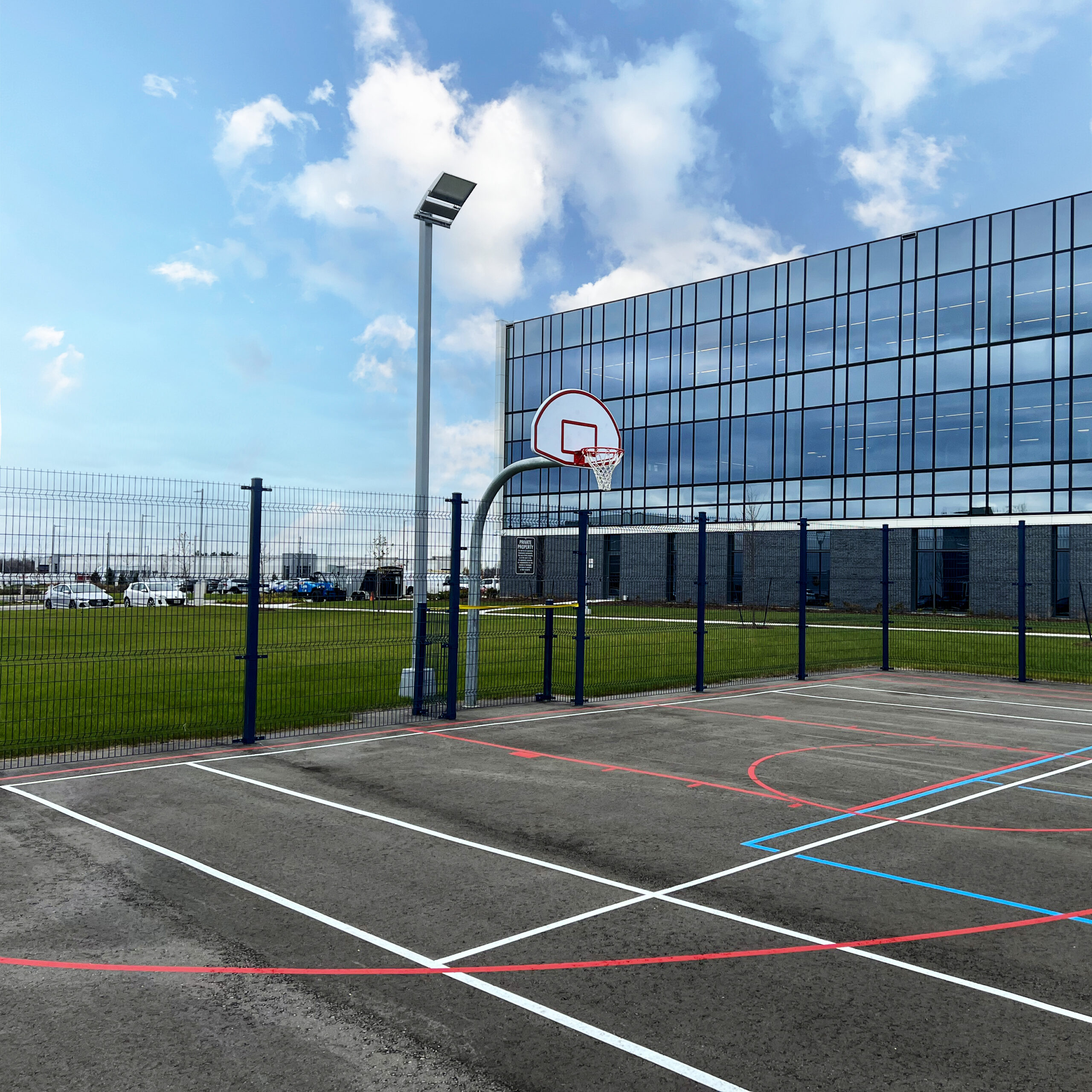 A basketball court surrounded by Architectural fence systems from Omega II at the Co-operators head office in Guelph.