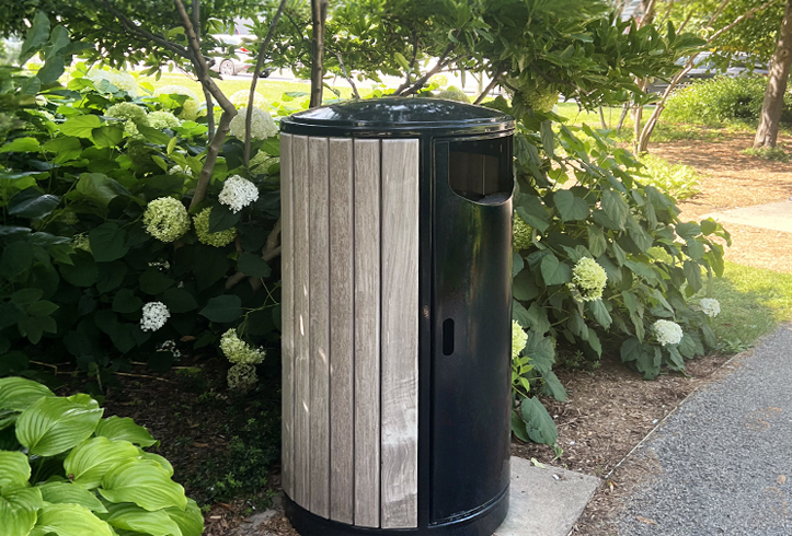 Victor Stanley Ren Side Door Receptacle installed alongside a pedestrian pathway.